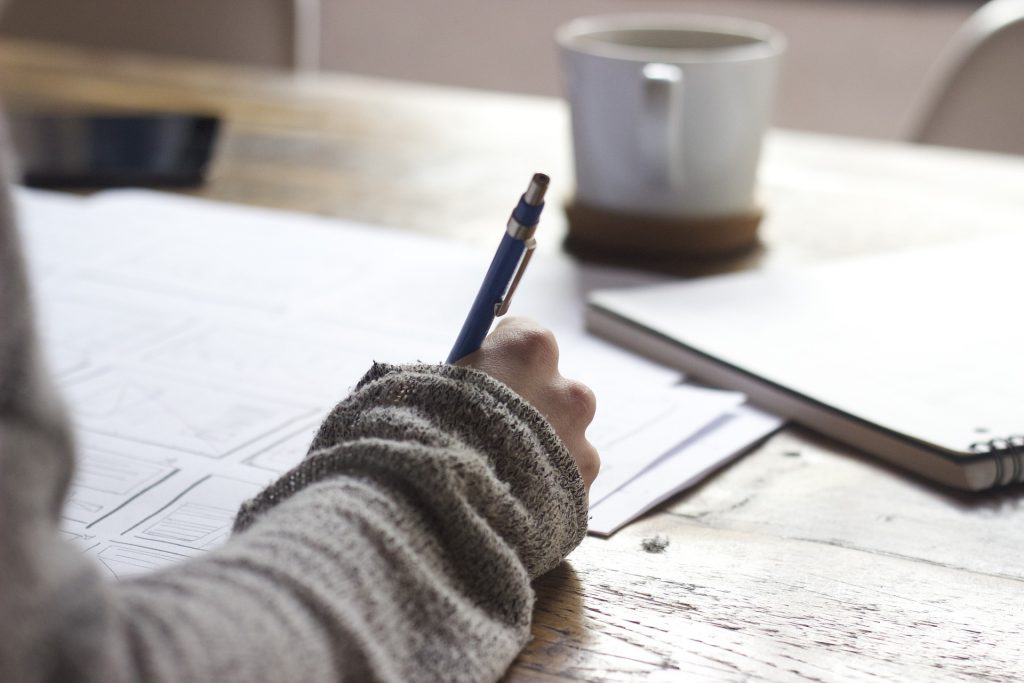 Public sector tendering paperwork, business person taking notes