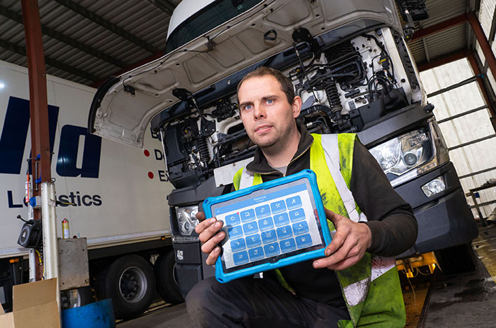 A McCulla Ireland engineer using a tablet to access Freeway Fleet Systems in the McCulla workshop