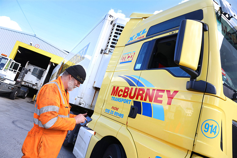 A McBurney Transport Group engineer using a tablet to access Freeway Fleet Systems