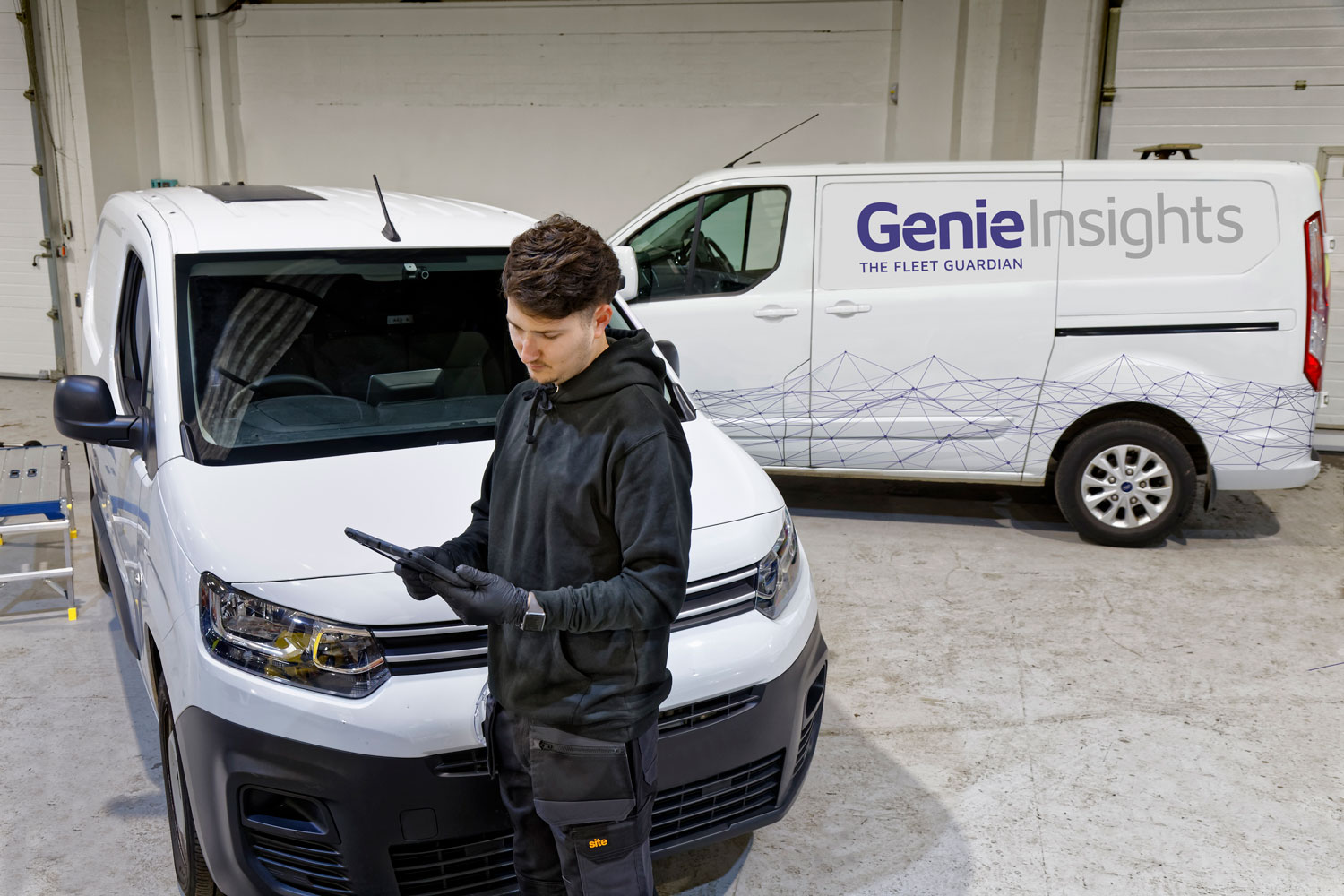 Fitter standing in front of Genie Insights Fleet Guardian van